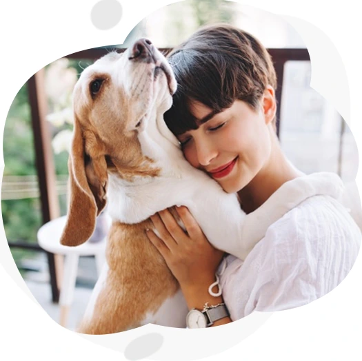 A pet owner hugging her beagle