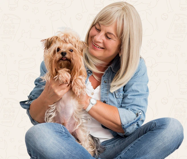 A pet owner cuddling her small dog